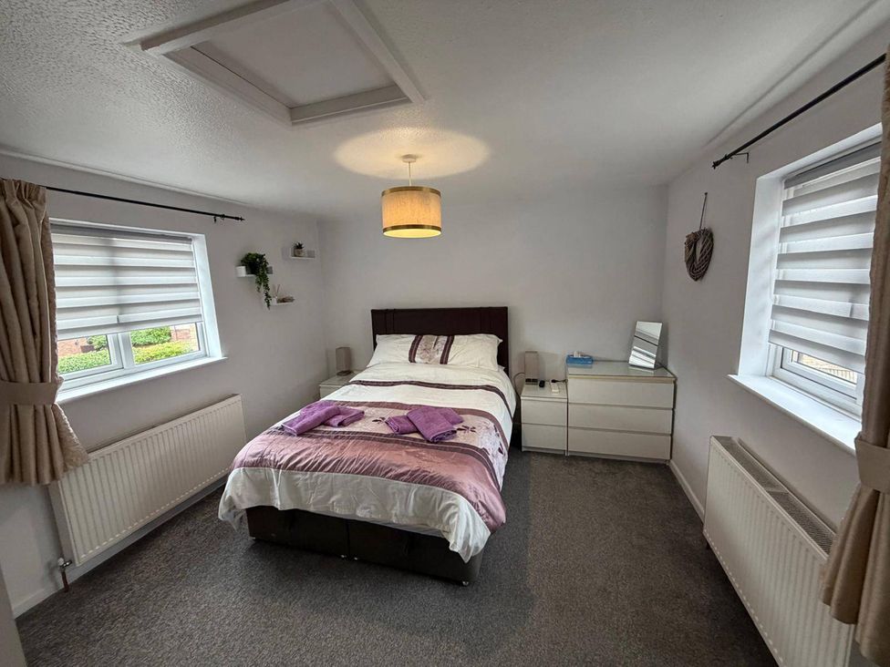 A bedroom with a bed and bedside table at Sleeps 5 pet friendly, Enclosed garden, Parking Belmont near Hereford