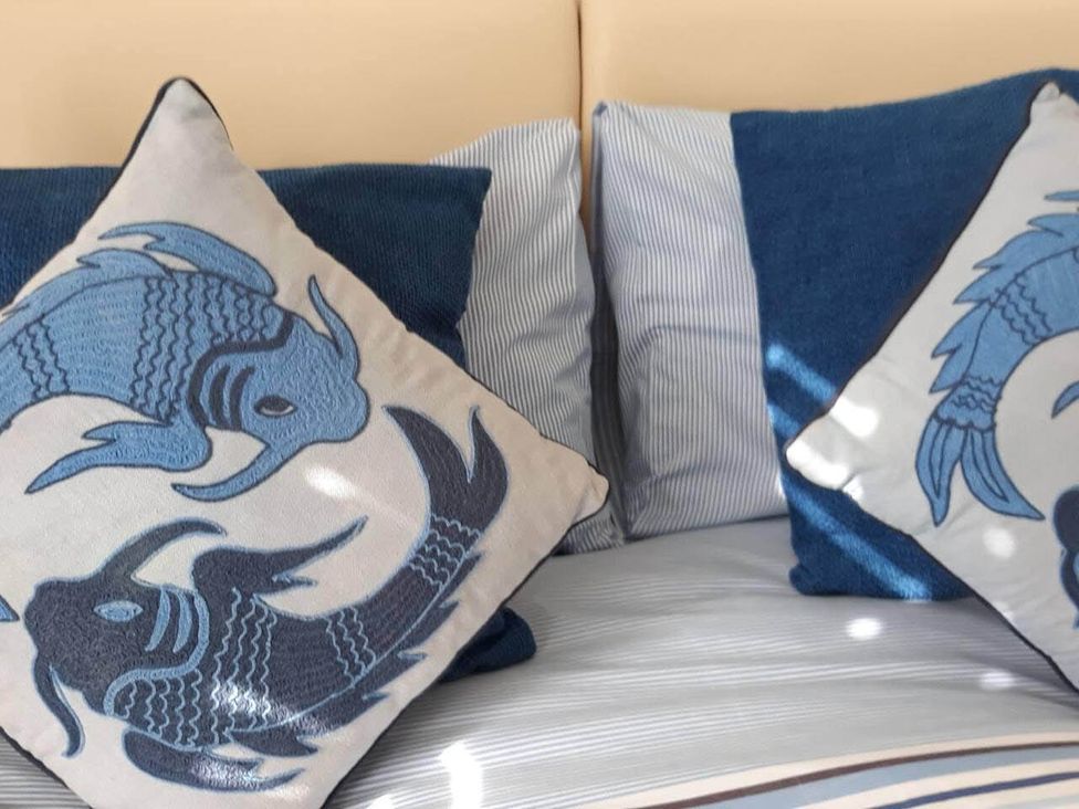 Two decorative pillows on a bed at Impeccable 3 bed 2 bath Central Cowes Cottage in Cowes