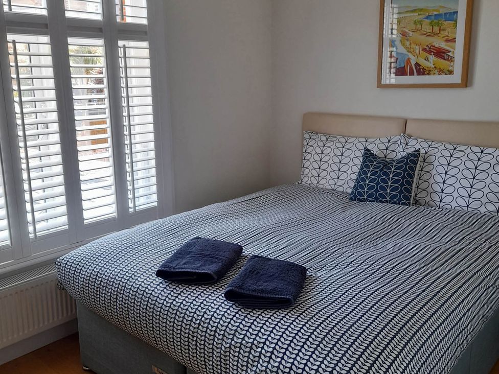 A bedroom with a bed and towels on it at Impeccable 3 bed 2 bath Central Cowes Cottage in Cowes