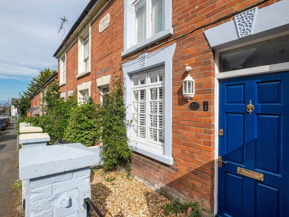 An exterior view of a house with a blue door and window at Impeccable 3 bed 2 bath Central Cowes Cottage Cowes