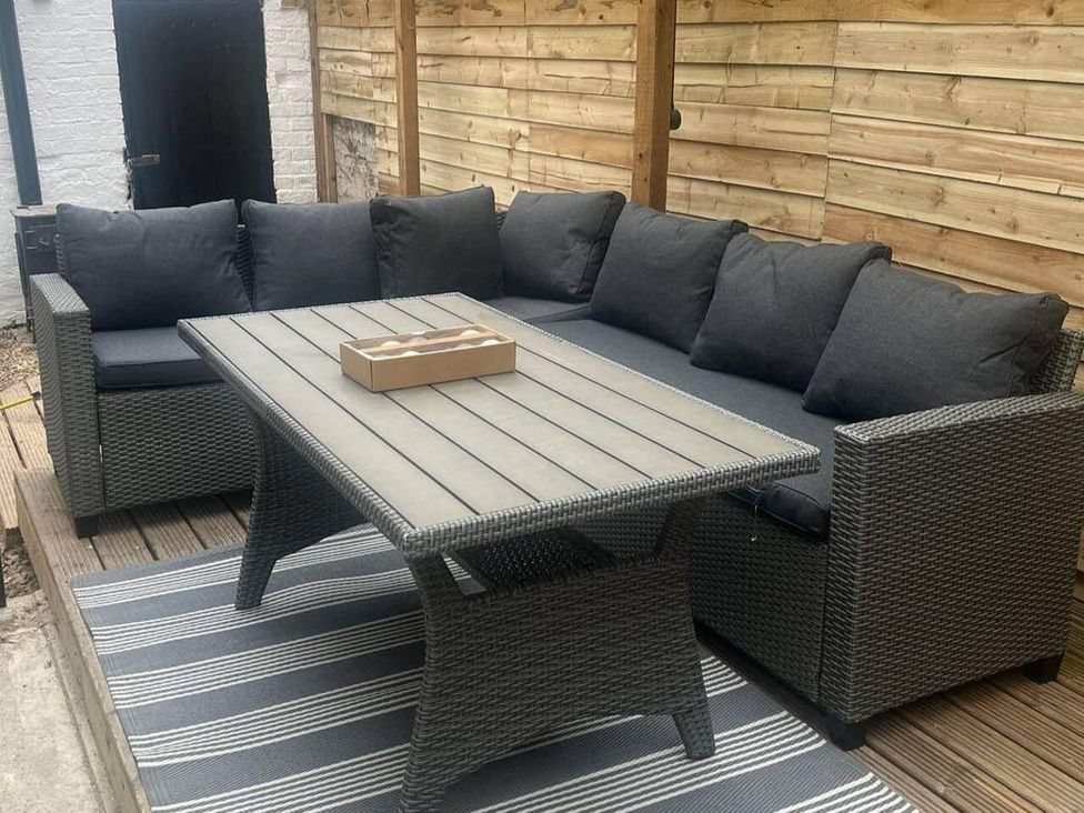 An outdoor patio with a sofa and table at Blyton 2-Bed Cottage, Parking, 30m to Lincoln, Gainsborough