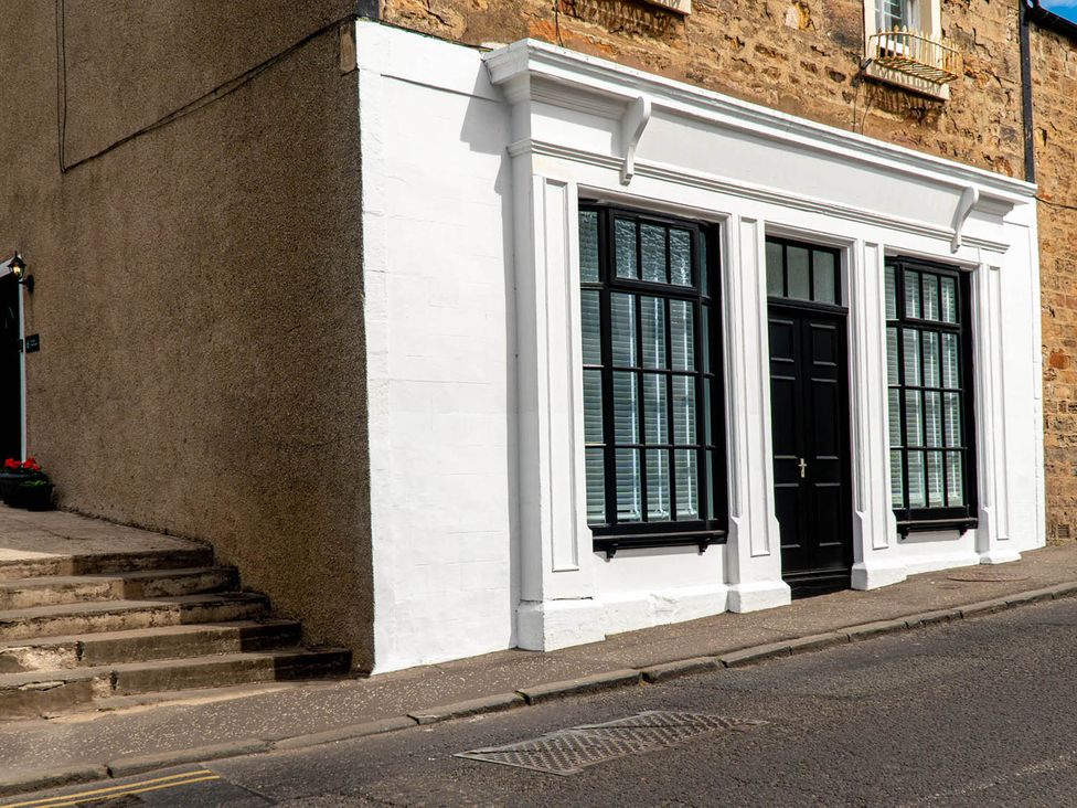 A building facade with windows and a door at The Old Paint Shop Apartment - Centrally Situated in Anstruther