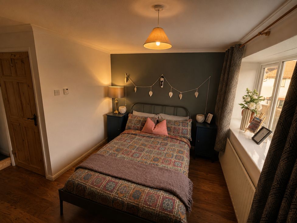 A bedroom with a bed, bedside table, and window at Family Friendly Coach House - Parking - Sleeps 4, Ebdon