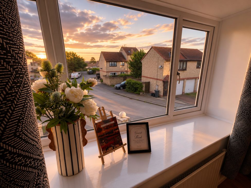 A window with flowers and a guest book at Family Friendly Coach House - Parking - Sleeps 4 Ebdon