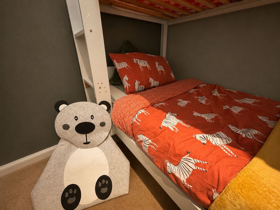 A bedroom with a bed and bear toy at Family Friendly Coach House - Parking - Sleeps 4 Ebdon