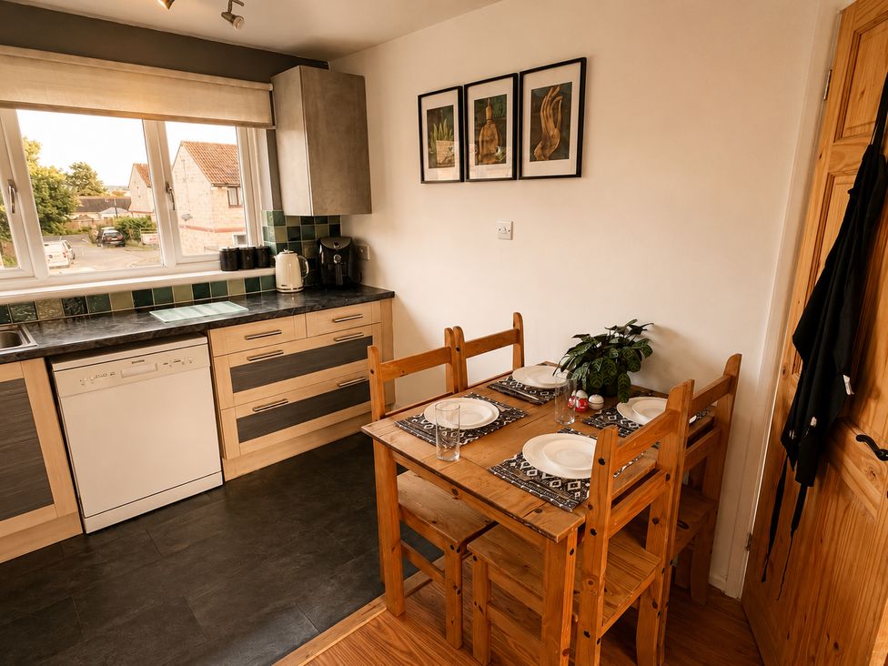 A kitchen with a dining table and chairs at Family Friendly Coach House - Parking - Sleeps 4 in Ebdon