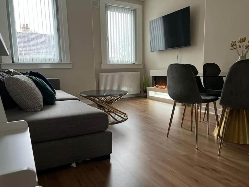 A living room with a sofa and television at 3 Bedroom Flat, sleeping 6 with free parking, Kirkcaldy