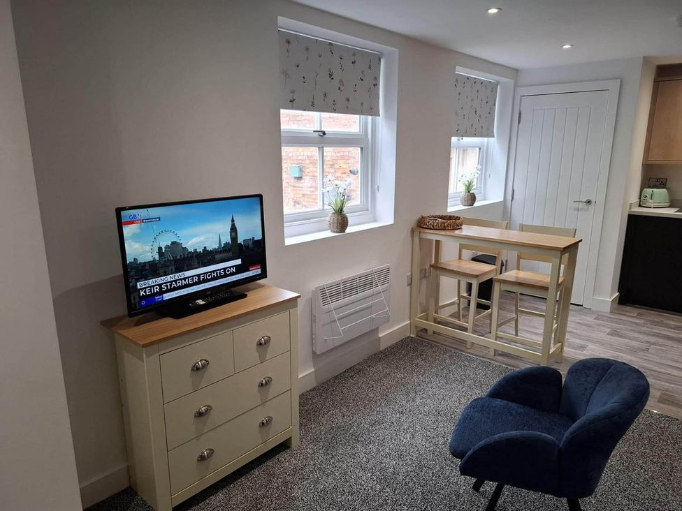 A living room with a television and furniture at Sleeps 2 in a Central Location and is family friendly, Retford