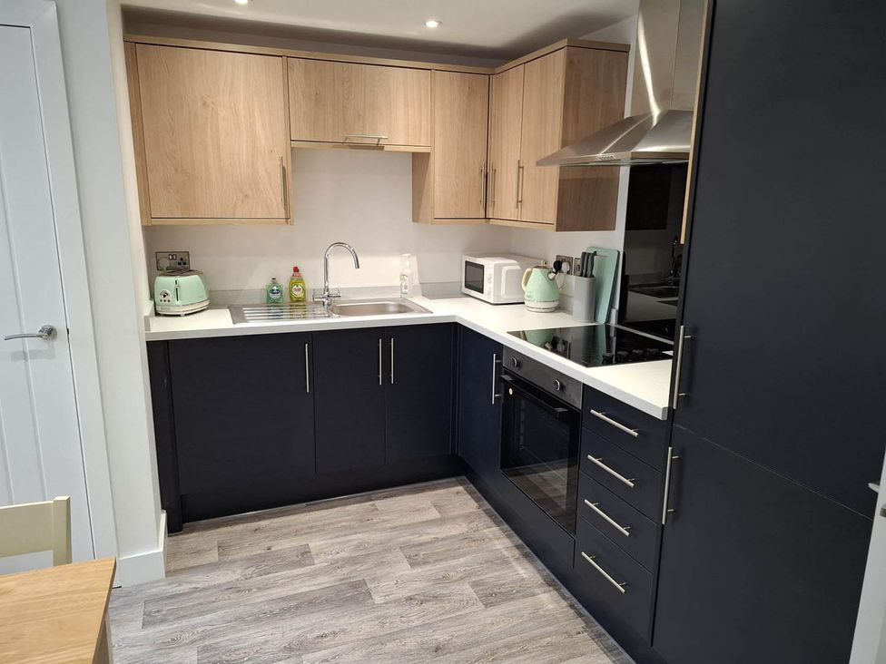 A kitchen with cabinets, sink, and appliances at Sleeps 2 in a Central Location and is family friendly, Retford