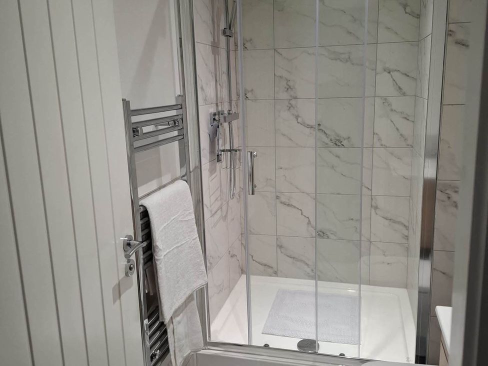 A bathroom with a shower and towel rack at Sleeps 2 in a Central Location and is family friendly, Retford