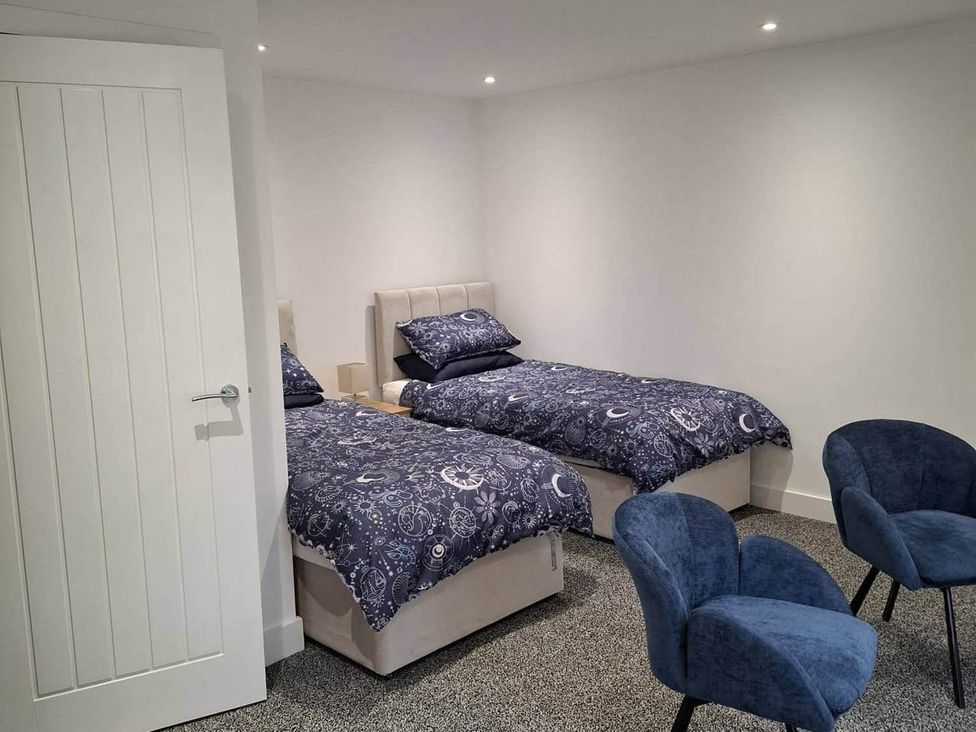 A bedroom with two beds and two chairs at Sleeps 2 in a Central Location and is family friendly, Retford