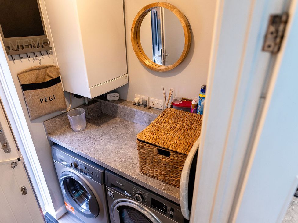 A laundry room with a washing machine and dryer at 3 Bedroom, sleeping 5 with Wifi Wythenshawe near Manchester