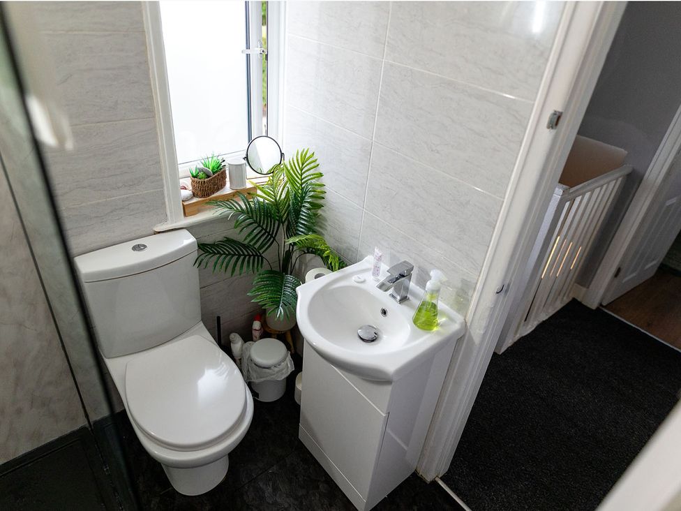 A bathroom with a toilet and sink at 3 Bedroom, sleeping 5 with Wifi Wythenshawe near Manchester
