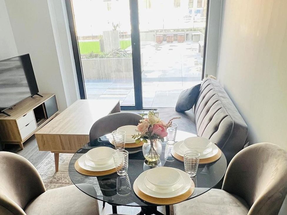 A dining area with table set for meals at Apartment near Old Trafford, Sleeping 3 with Garden and Parking, Manchester