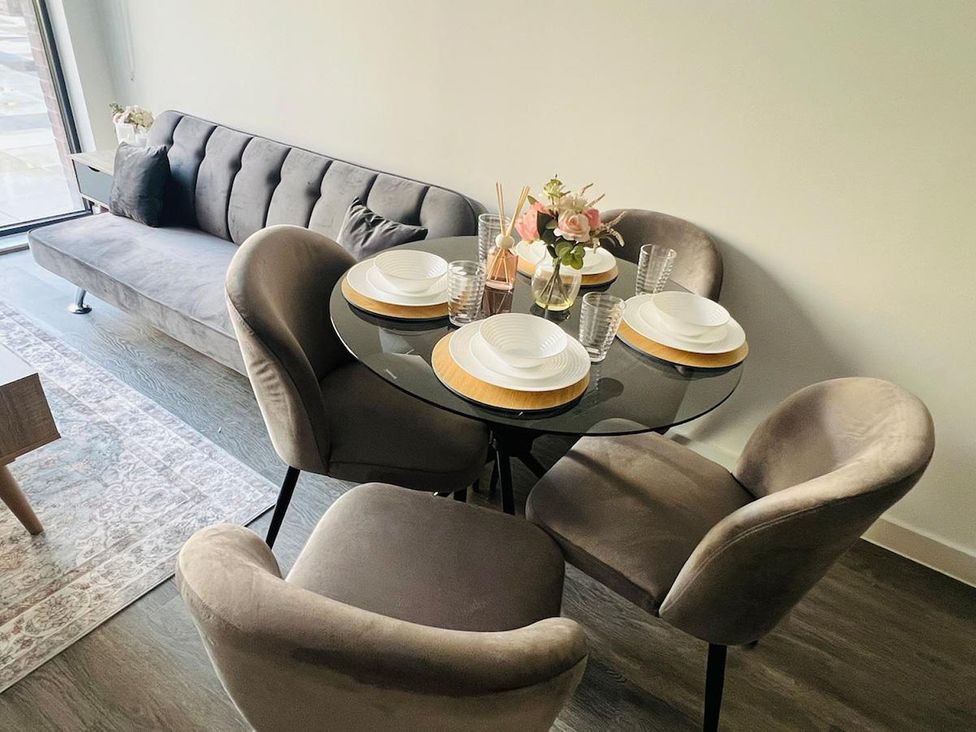 A dining room setup with a table and chairs at Apartment near Old Trafford, Sleeping 3 with Garden and Parking in Manchester
