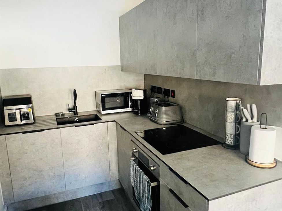 A kitchen with a sink, microwave and coffee maker at Apartment near Old Trafford, Sleeping 3 with Garden and Parking, Manchester