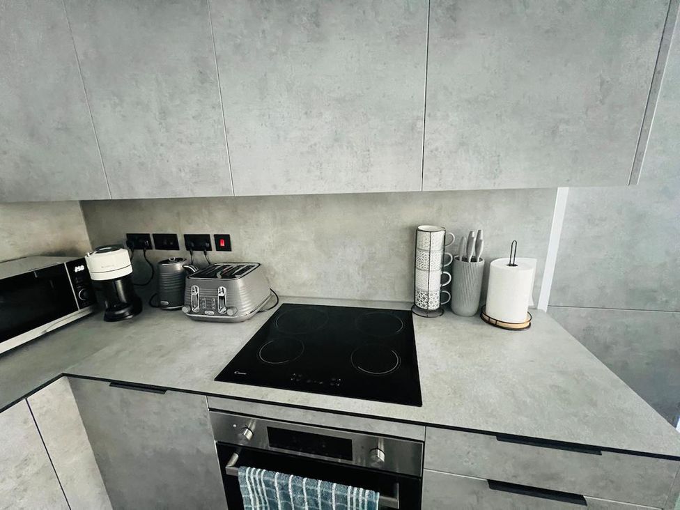 A kitchen with a microwave and coffee maker at Apartment near Old Trafford, Sleeping 3 with Garden and Parking, Manchester