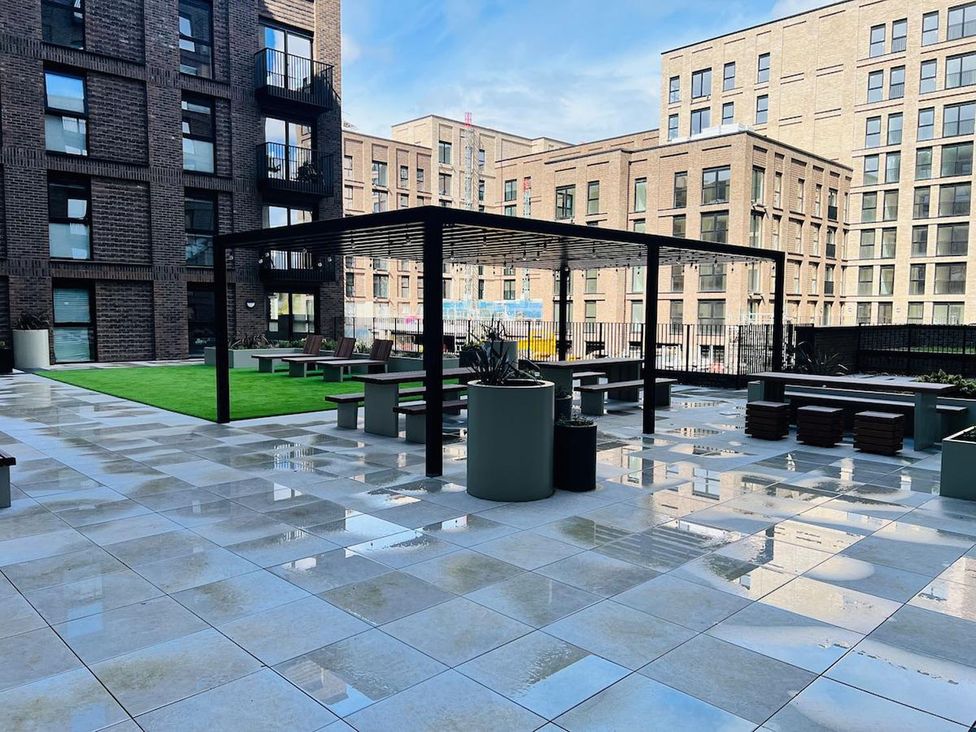 An outdoor area with seating and planters at Apartment near Old Trafford, Sleeping 3 with Garden and Parking, Manchester