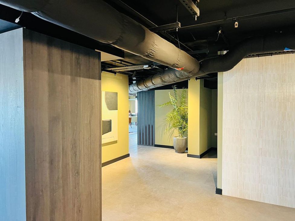A hallway with a plant and pillars at Apartment near Old Trafford, Sleeping 3 with Garden and Parking, Manchester