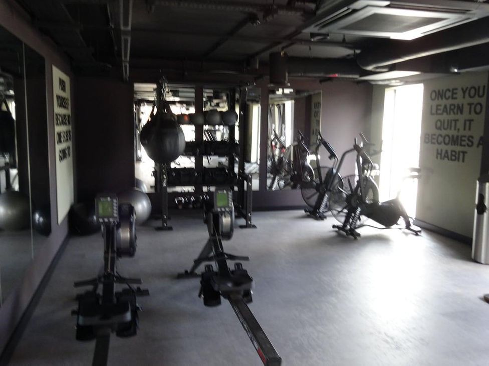A gym with rowing machines and exercise equipment at Apartment near Old Trafford, Sleeping 3 with Garden and Parking, Manchester