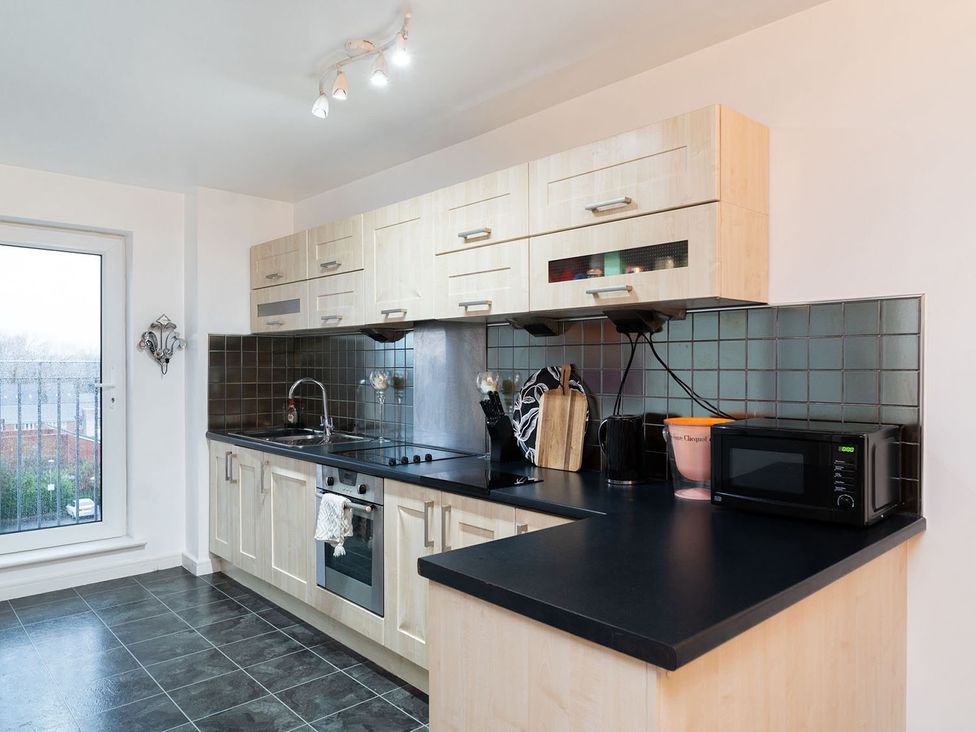 A kitchen with cabinets and appliances at Apartment, Sleeps 6 with Stadium View in Manchester