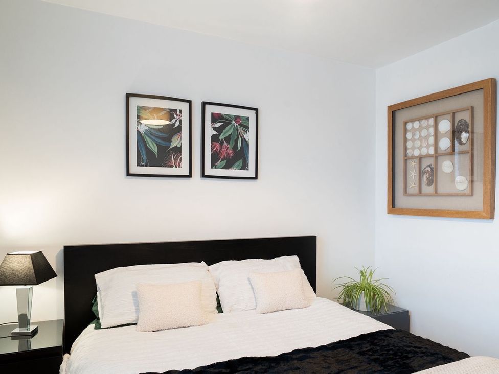 A bedroom with a bed and framed art at Apartment, Sleeps 6 with Stadium View in Manchester