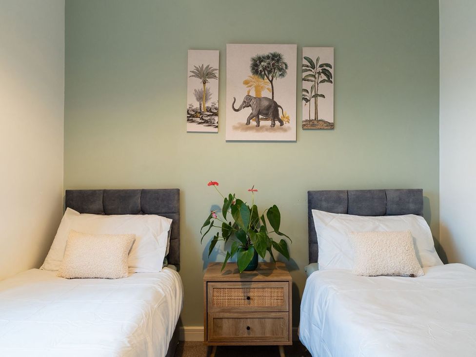A bedroom with two beds and a plant at Apartment, Sleeps 6 with Stadium View in Manchester