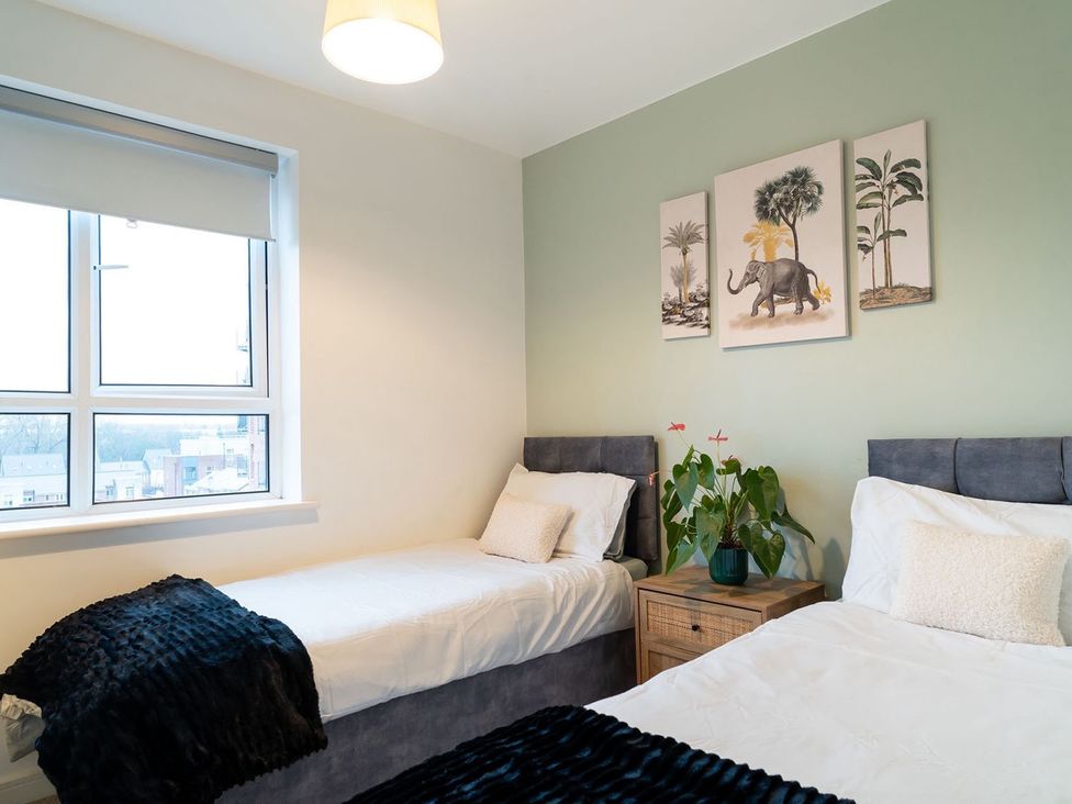 A bedroom with two beds and wall art at Apartment, Sleeps 6 with Stadium View in Manchester