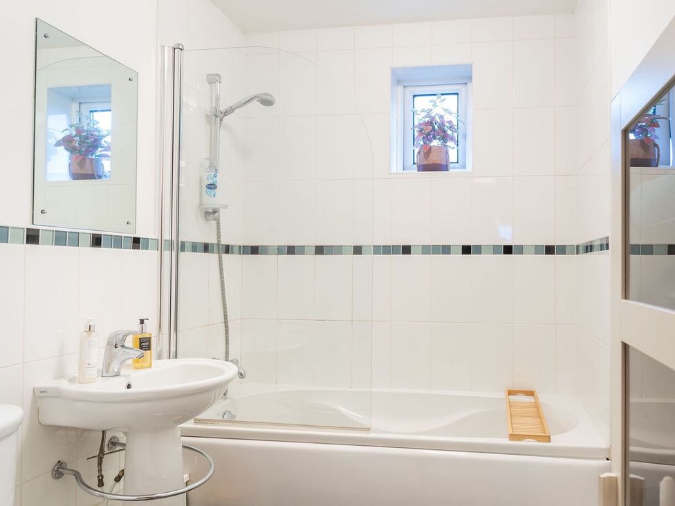 A bathroom with a bathtub, sink, and shower at Apartment, Sleeps 6 with Stadium View, Manchester