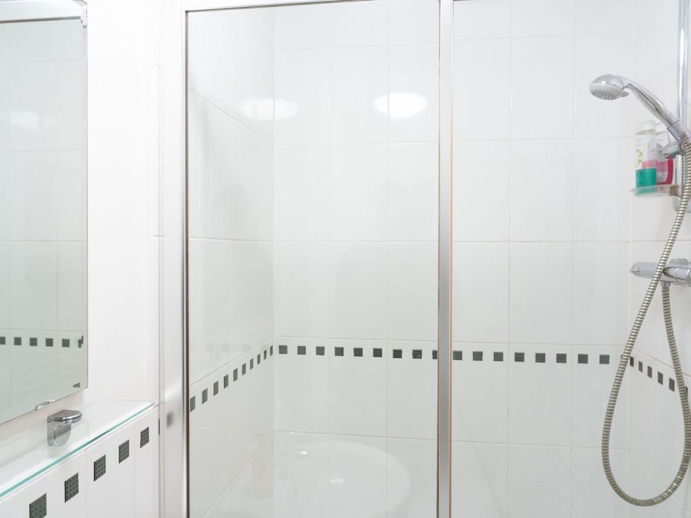 A bathroom with a shower and mirror at Apartment, Sleeps 6 with Stadium View, Manchester