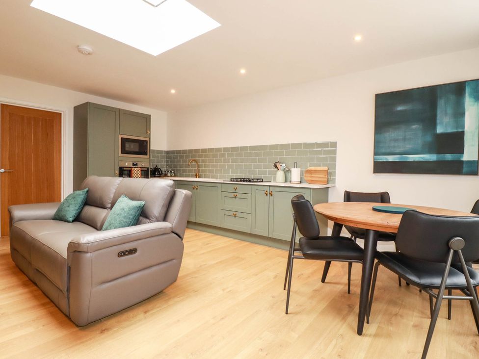 A kitchen with a sofa and dining area at Rule retreat in Penzance