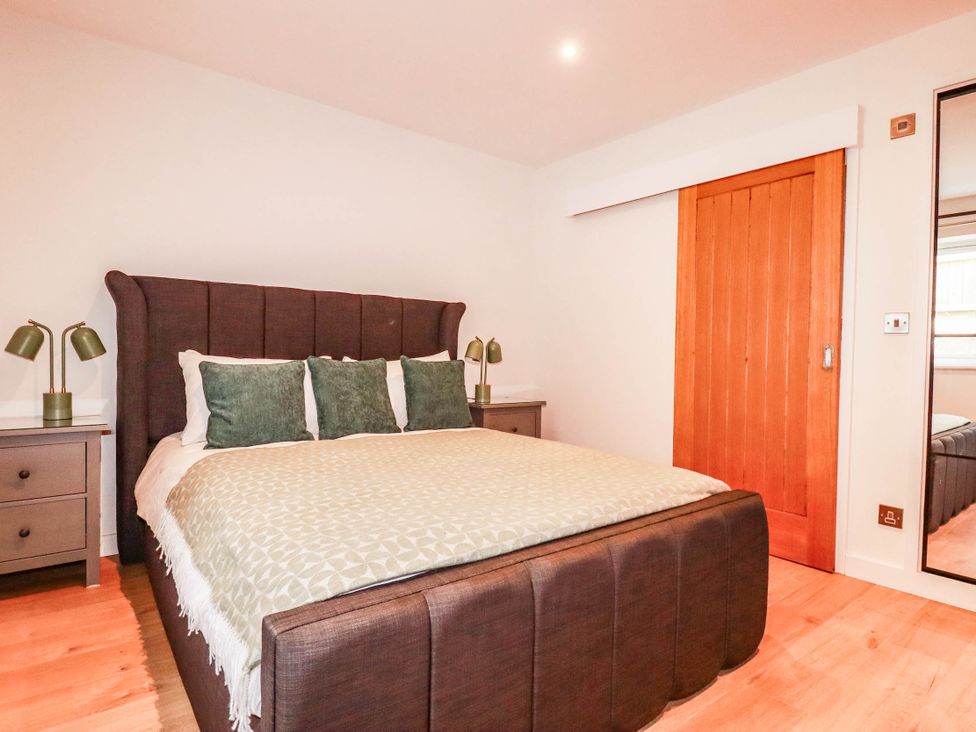 A bedroom with a bed and nightstands at Rule retreat in Penzance