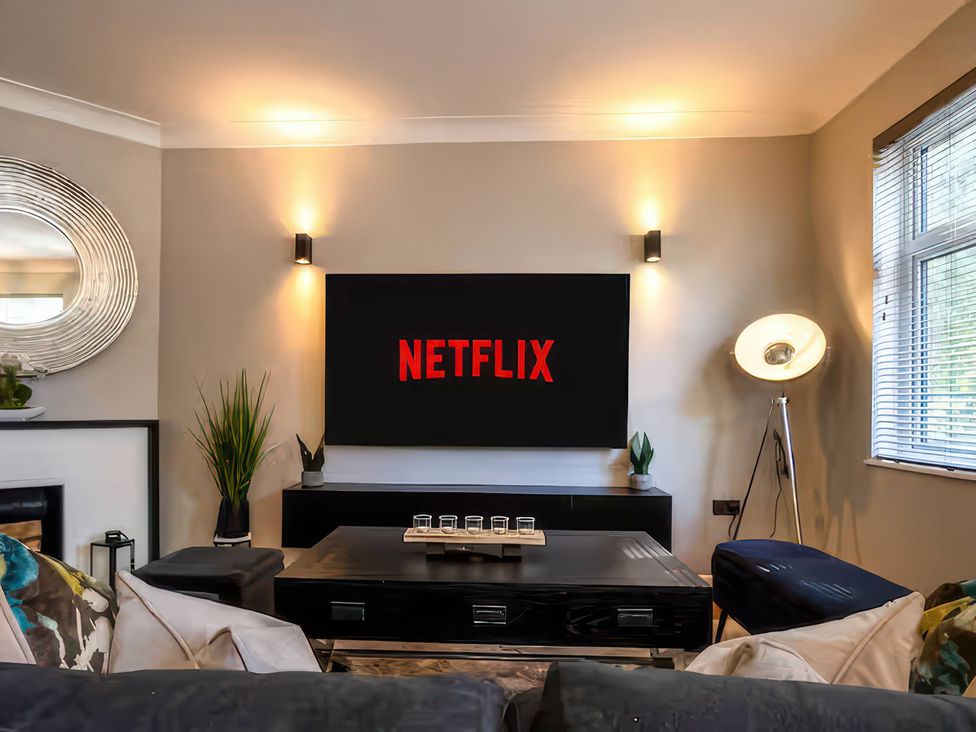 A living room with a television displaying Netflix logo at 7 Wolsey Mansions Northwood, Hertfordshire