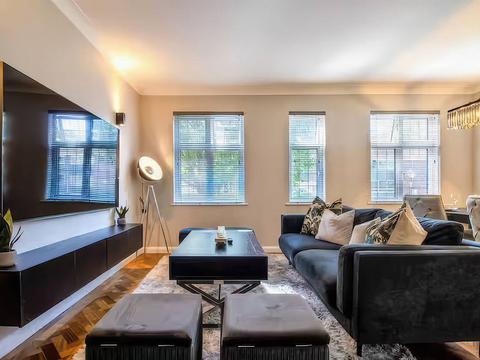 A living room with a sofa and coffee table at 7 Wolsey Mansions, Northwood, Hertfordshire