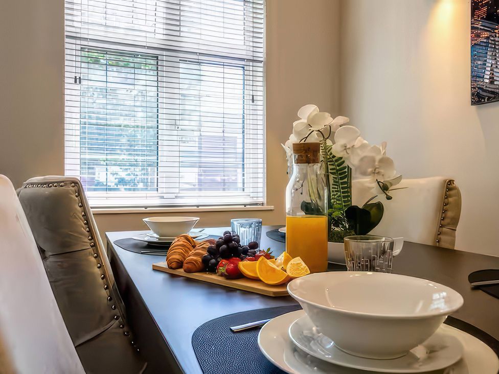 A dining room with a table set for breakfast at 7 Wolsey Mansions Northwood Hertfordshire