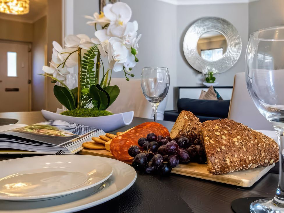 A dining room with food items and decor at 7 Wolsey Mansions in Northwood, Hertfordshire