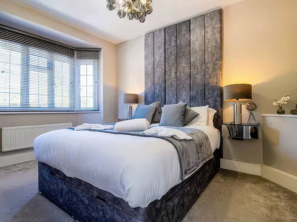 A bedroom with a bed and window at 7 Wolsey Mansions Northwood, Hertfordshire