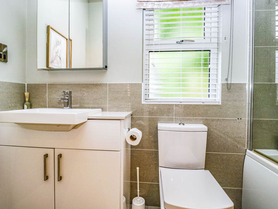 A bathroom with a sink and toilet at 19 Pony Meadow White Cross Bay near Troutbeck Bridge