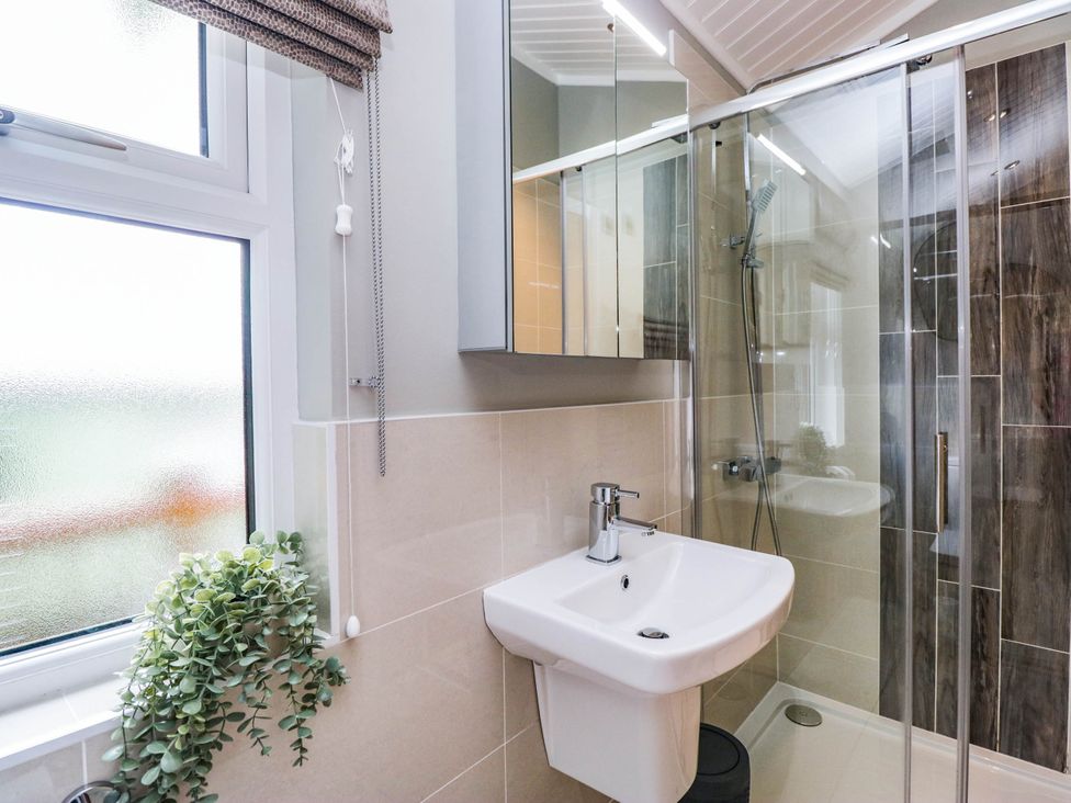 A bathroom with a shower and sink at 19 Pony Meadow White Cross Bay near Troutbeck Bridge