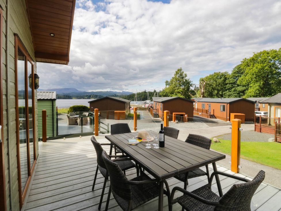 An outdoor seating area with a table and chairs at 19 Pony Meadow near Troutbeck Bridge