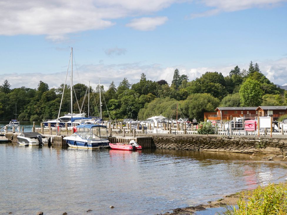 A marina with boats and surrounding trees at 19 Pony Meadow near White Cross Bay