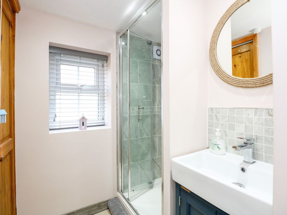 A bathroom with sink and shower at Beck Cottage in Sheringham