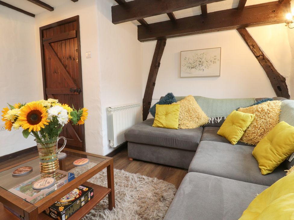A living room with a couch and coffee table at The Thatched Cottage in Preston
