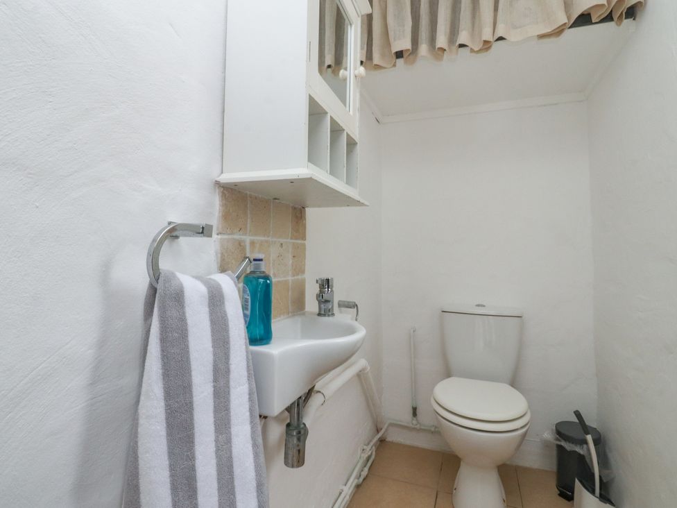 A bathroom with a sink and toilet at The Thatched Cottage in Preston