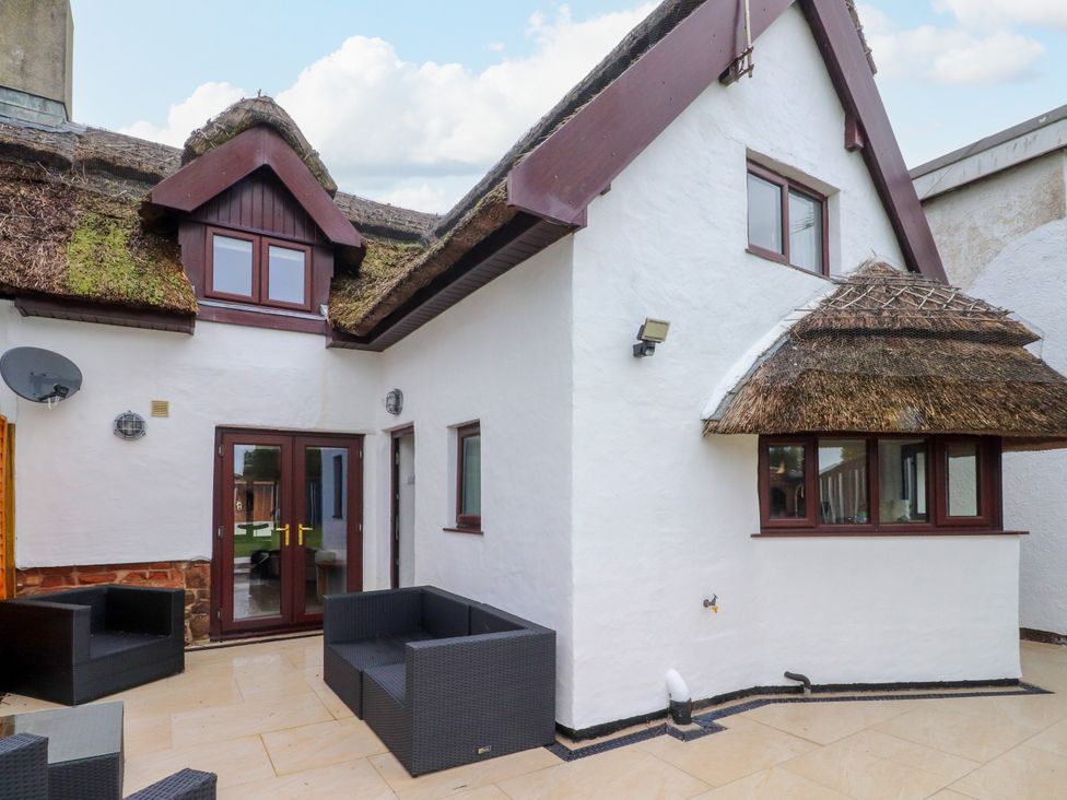 An outdoor area with patio furniture at The Thatched Cottage in Preston