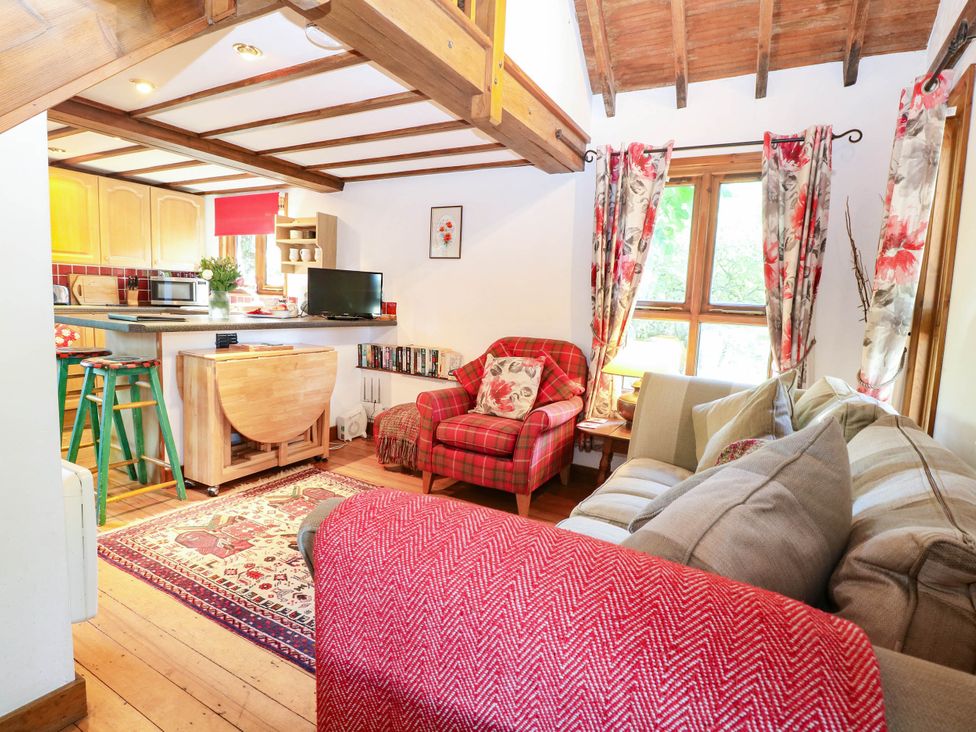 A living room with a sofa and armchair at Corner Barn North Burlingham near Blofield