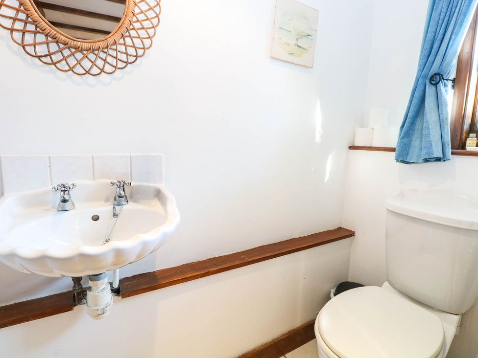 A bathroom with a sink and toilet at Corner Barn North Burlingham near Blofield