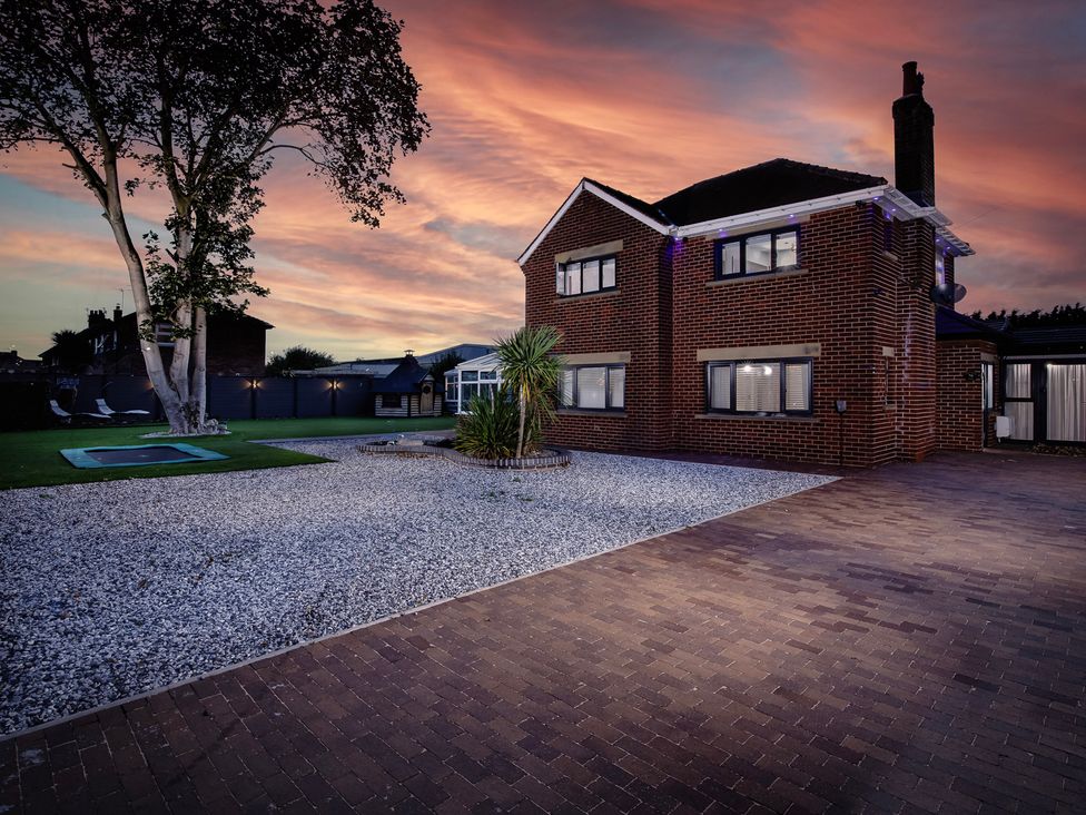 A house with a driveway and trees at Wind Farm in 