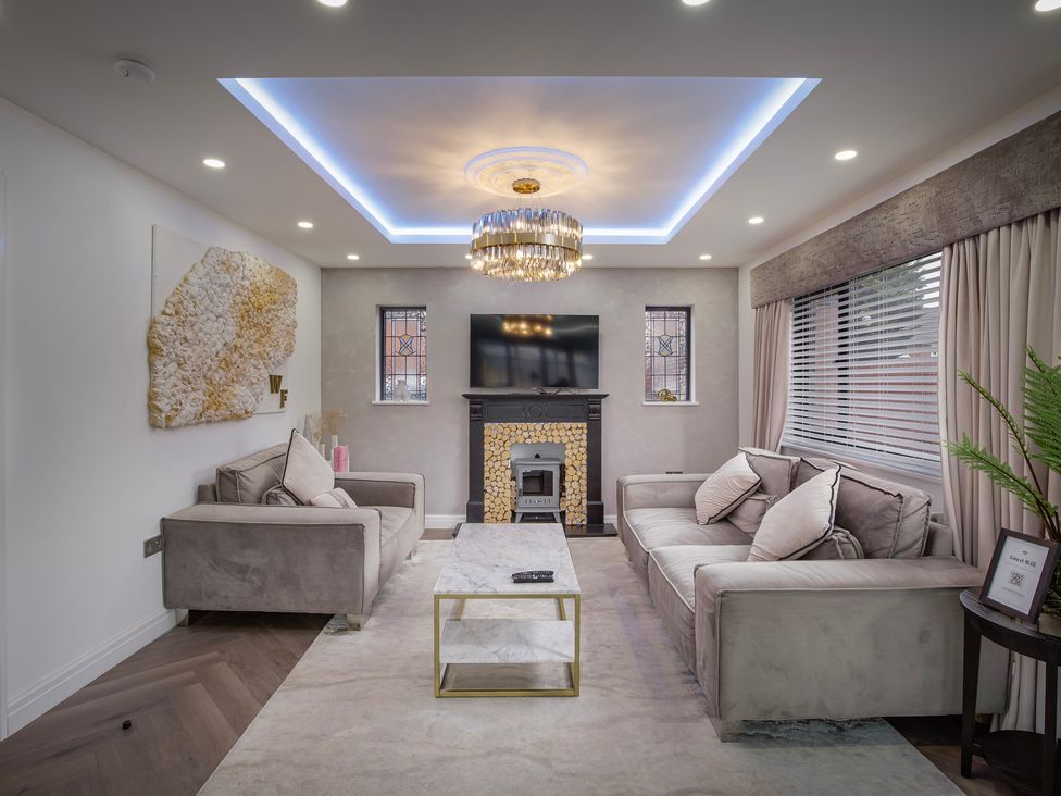 A living room with two sofas, a coffee table, and a television at Wind Farm