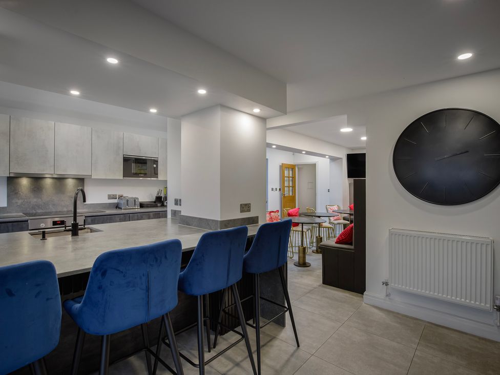 A kitchen with a counter and stools at Wind Farm 